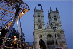 Workers set up lights on a media stand outside Westminster Abbey earlier this week.