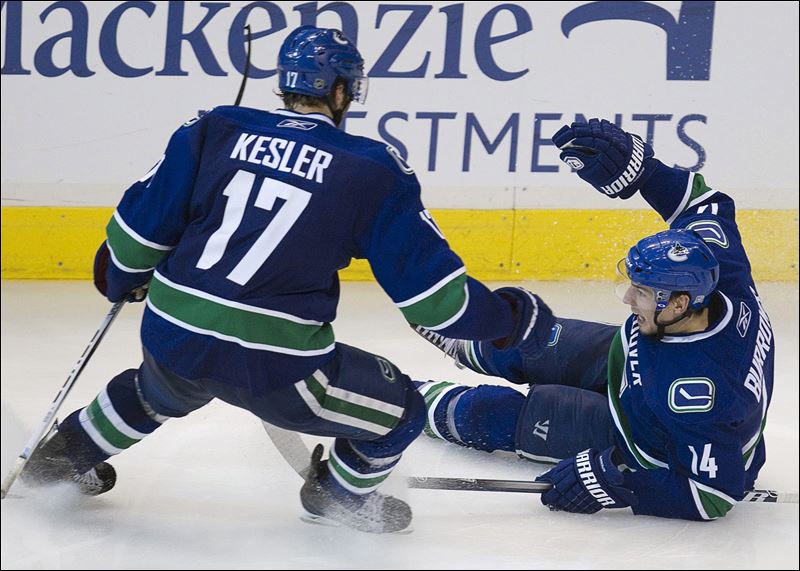 Vancouver Canucks' Alex Burrows right celebrates his game winning goal 
