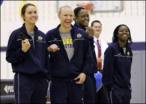 Ms. Ingersoll and teammates Haylie Linn, Brianna Jones, and Janelle Reed-Lewis, from left, enjoy the students' questions.