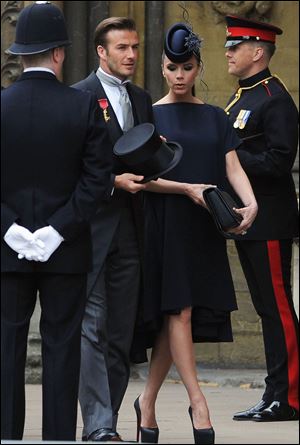 English soccer player David Beckham arrives with wife Victoria Beckham for the wedding.