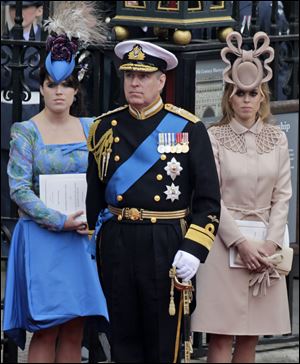Britain's Prince Andrew and daughters Princess Eugenie, left, and Princess Beatrice leave Westminster Abbey after the royal wedding of Andrew's nephew William to Catherine Middleton.