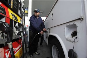 A motorist fills up at a Shell gas station in Seattle earlier this month.
