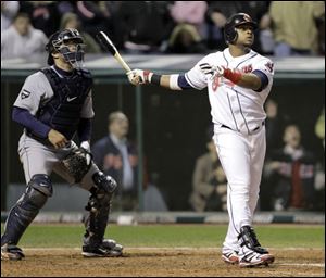 Indians catcher Carlos Santana watches the flight of his game winning three-run walk off home run off Tigers relief pitcher Joaquin Benoit in the ninth inning.