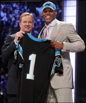 Cam Newton holds a jersey with NFL commissioner Roger Goodell after being taken with the No. 1 pick in the draft by Carolina. The Heisman Trophy winner led Auburn to the national championship.