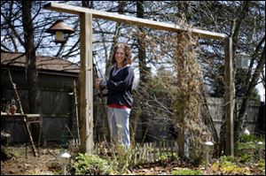 Rita Dreyer stands in one of her backyard gardens.