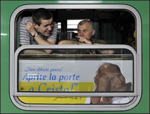 Polish pilgrims travel on a special train headed for Rome from Katowice, southern Poland, late evening Friday.