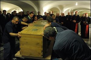 The coffin of late Pope John Paul II is prepared for transfer from the crypts below St. Peter’s Basilica.