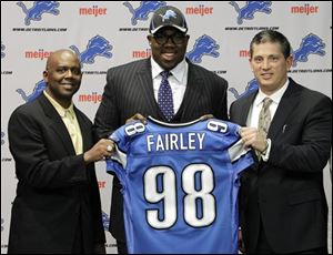 Detroit Lions general manager Martin Mayhew, from left, first-round draft pick Nick Fairley, and head coach Jim Schwartz pose at the team's headquarters in Allen Park, Mich. on Friday. The Lions chose based on best talent early and on need late.