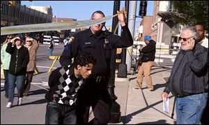 A man is arrested by police at a free-speech rally by Rev. Terry Jones in Dearborn, Mich. Other protesters gathered to demonstrate against Mr. Jones.