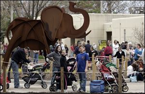 A large crowd gathers to catch a glimpse of 8-year-old Louie tackling his presents and birthday cake. An estimated 4,600 people from Lucas County and beyond attended the annual birthday celebration for the Toledo Zoo’s youngest elephant.