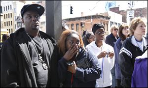 Enrico Guy, left, and Dwanise Guy, second from left, attend the annual Child Memorial in Toledo. Mr. Guy’s 16-year-old son and Ms. Guy’s stepson, Kantraylious Guy, was a victim of a gunshot wound.
