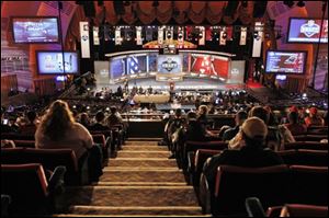 Fans look on during the fourth round of the NFL football draft by the at Radio City Music Hall Saturday in New York. 