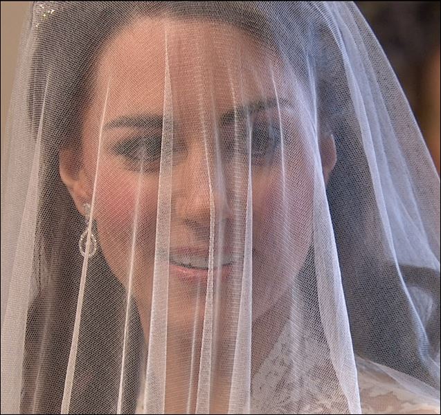 Kate Middleton's face is covered by her veil before she reaches the altar at