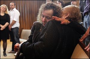 Bella Wagner, left, hugs Clara Rona, a Holocaust survivor, after watching 