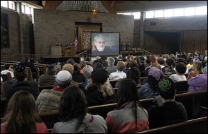 About 150 people watch a documentary about local Holocaust survivors during Yom HaShoah, or Holocaust Remembrance Day, at The Temple-Congregation Shomer Emunim.