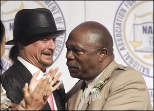 Kid Rock is embraced by NAACP President Wendell Anthony at the organization's annual fund-raising dinner in Detroit.