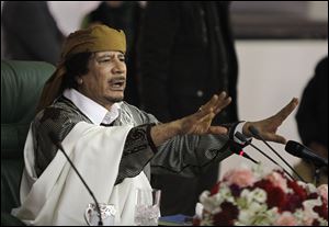 Embattled leader Moammar Gadhafi speaks to supporters in Tripoli. Hours before Saturday’s attack, Gadhafi proposed a cease-fire in a defiant and rambling televised speech. NATO and the rebels rejected the call as a ploy and vowed to keep pressure on the government.