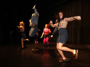 Claire Parlette, foreground, and other students at Sylvania Southview rehearse for a production of ‘Footloose.’ School officials say theater productions and other activities
such as student publications would be eliminated if Tuesday’s 4.9-mill levy is rejected.