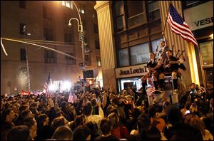 A large, jubilant crowd, including bagpipers, reacts to the news of Osama Bin Laden's death at the corner of Church and Vesey Streets, adjacent to ground zero, during the early morning hours Monday.