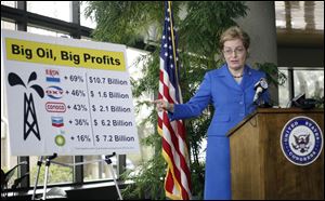 U.S. Rep. Marcy Kaptur gestures toward a chart showing major oil companies' profit increases. Speaking Sunday outside the Toledo-Lucas County Port Authority's offices, she called on the Speaker of the U.S. House to allow a vote on ending tax breaks for the companies. 