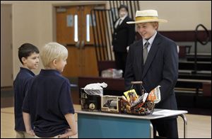 Seventh grader Hunter Rudolph, right, from Perrysburg,  is dressed as Milton S. Hershey, the founder of The Hershey Company.