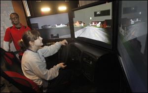 Bethany DuBell takes her turn on the drinking-and-driving simulator during the Natinoal Save A Life Tour -- High Impact Awareness Program at Maumee High School.