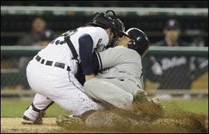 New York's Andruw Jones, right, is tagged out by Detroit catcher Alex Avila during the fourth inning of the Tigers' 4-2 win over the Yankees Tuesday night at Comerica Park.