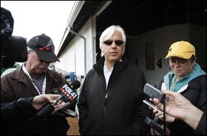 Trainer Bob Baffert talks with reporters Monday at his barn in the stable area of Churchill Downs. Baffert trains Kentucky Derby hopeful Midnight Interlude. 
