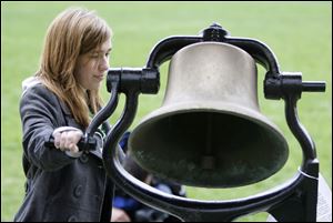 Halie Doyle, 16, rings the Victory Bell at Kent State University during commemoration services Wednesday for the four students who were killed May 4, 1970, at Kent State during Vietnam war protests.