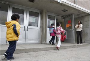 Students arrive for a school day at Pickett Academy under the watchful eye of Principal Martha Jude. In
2008, after years of failing test scores, officials in the Toledo Public Schools system remade Pickett, replacing most of its teachers and leadership, hoping to turn the school around.