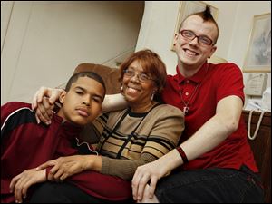 Patricia Hitt, center, made sure she laid out strong ground rules for her adopted children, including, from left, Jonathan Hitt, 16, and Fred Hitt, 17. Fred was getting into trouble but is thriving now with the help of a mentor.