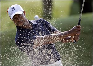 Tiger Woods hits from the sand on the sixth hole during the first round of The Players Championship golf tournament Thursday May 12, 2011 in Ponte Vedra Beach, Fla. Woods withdrew from the tournament after nine holes. (AP Photo/Chris O'Meara)