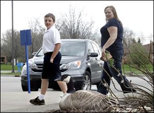 Logan Blockway, 11, and his mother, Hanna Blockway, were just two people to notice the goose atop her nest near the post office door.