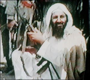 Osama bin Laden holds an AK47 automatic rifle in an image from an undated recruitment video tape for his organization, as viewed by The Associated Press in Kuwait City in 2001. 