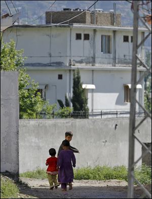 Pakistani children earlier this week walk past the house of former al-Qaida leader Osama bin Laden in Abbottabad, Pakistan.