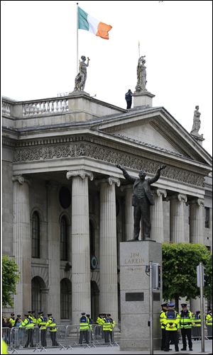 The Irish tricolor flies over the General Post Office, one of the major sites of the 1916 Easter Uprising against British Rule, in the center of Dublin, Ireland. The statue is to Irish trade union leader Jim Larkin.
