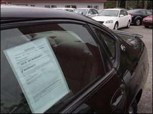 The manager of the Brown Super Center lot in Sylvania Township says dealers are bidding aggressively at used-car auctions to ensure they have inventory to last until Japan's problems are resolved.