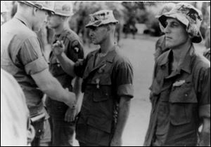 Sgt. William Doyle, center, in soft-brimmed hat, received a medal at Phan Rang in November, 1967. He has admitted killing Vietnamese civilians. 