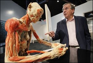 Dr. Roy Glover, chief medical director for Bodies Revealed, conducts a tour of the exhibit at the Imagination Station in Toledo.