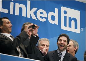 Jeff Weiner, second from right, LinkedIn's CEO, celebrates the company's listing Thursday at the New York Stock Exchange.