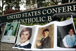 Photos of children who were abused by Catholic clergy line the sidewalk outside the U.S. Conference of Catholic Bishops before the abuse study findings were released.