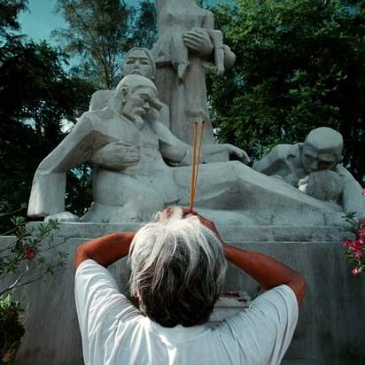 Vo-Van-Sac-60-burns-incense-and-prays-in-front-of-the-memorial-at-My-Lai