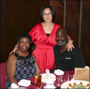 Yuan Xiaohona, center, joins the mayor's mother, Ora Bell, and Mayor Mike Bell. Ms. Yuan is a business partner in Dashing Pacific Ltd., the group that purchased The Docks restaurant complex.