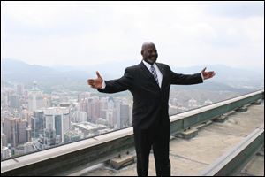  Toledo Mayor Mike Bell stands atop the Empire Building in Shenzhen, China.      