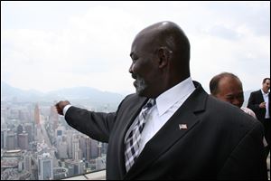 Mayor Mike Bell, wearing an American flag pin on his lapel, takes in a view of the city of Shenzhen, China, from atop the Empire Building as the mayor and other local officials began to form relationships with Chinese businessmen.