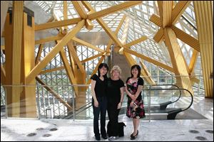 Amy Chang, left, the Toledo Symphony’s associate principal cellist, Kathy Carroll, the symphony’s president and chief executive, and Xia Xu, the Shenzhen Concert Hall’s artistic director, gather inside the four-year-old building.
