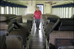 Clarice Wyse looks over the seats in the Blue Bird where the bottom half of the seat has been stolen.