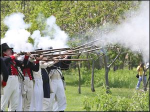 Re-enactors perform a musket demonstration at the River Raisin National Battlefield Park. 