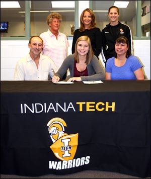 Stacy Nagy, center, a Bedford High School senior signs to play volleyball at Indiana Tech in Fort Wayne, Ind.