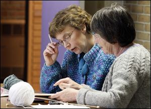 Karen O'Brien and Faye Schurman are part of the knitting group that is turning $50 worth of yarn into fingerless gloves to be sold for $10 a pair. Jane Kohlenberg used her seed money to launch the charity fund-raiser.